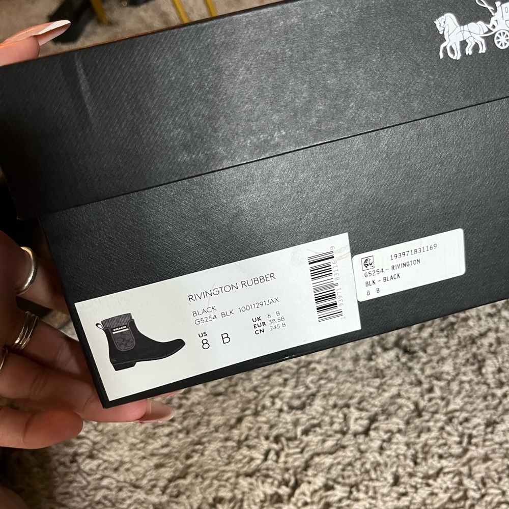 Shiny black Coach boots never worn
